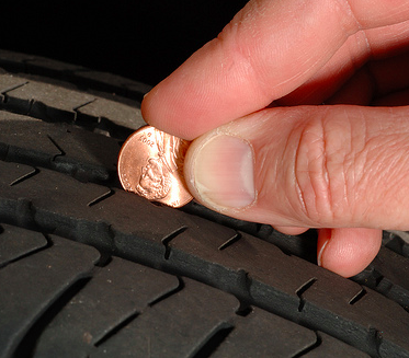 Using a penny to check the tread of a trailer tire