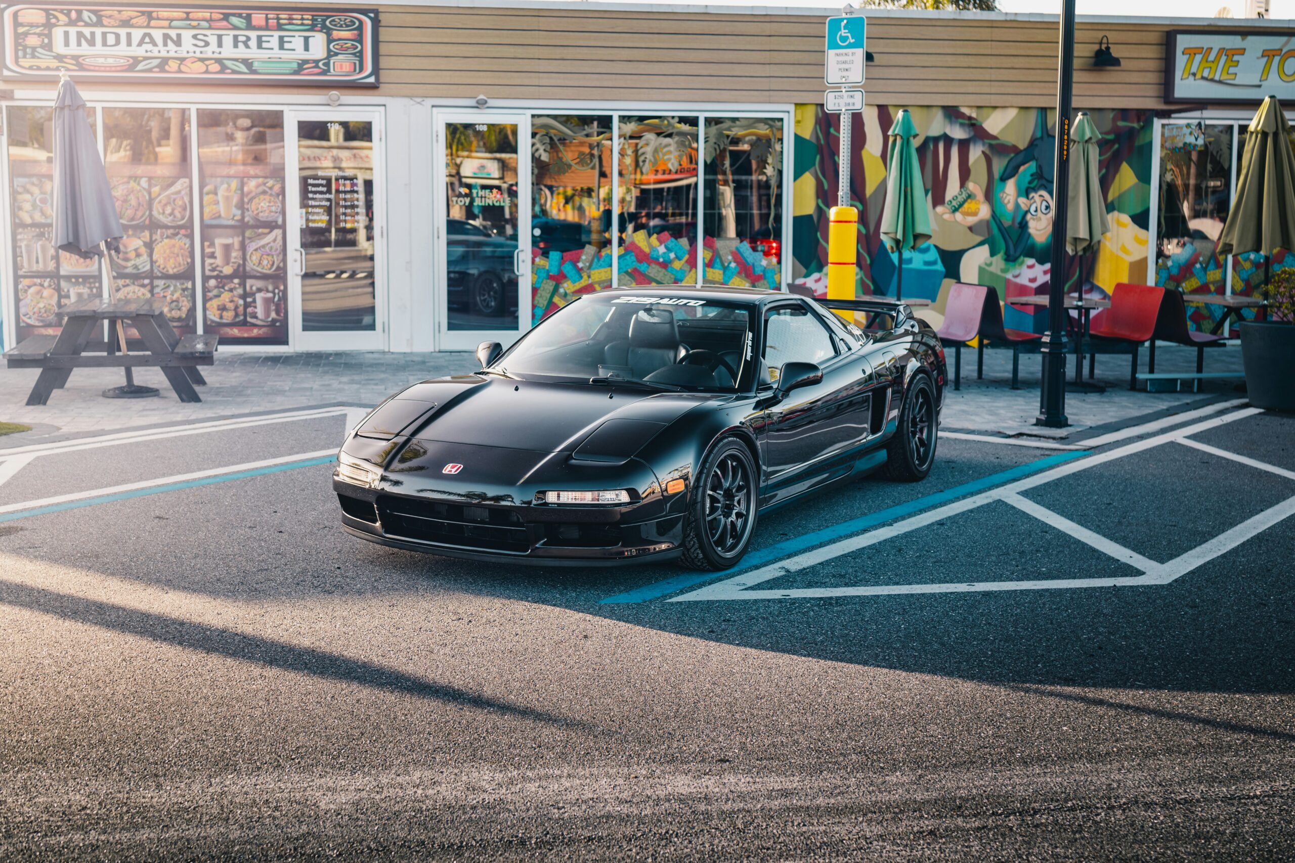 a black sports car parked on a street