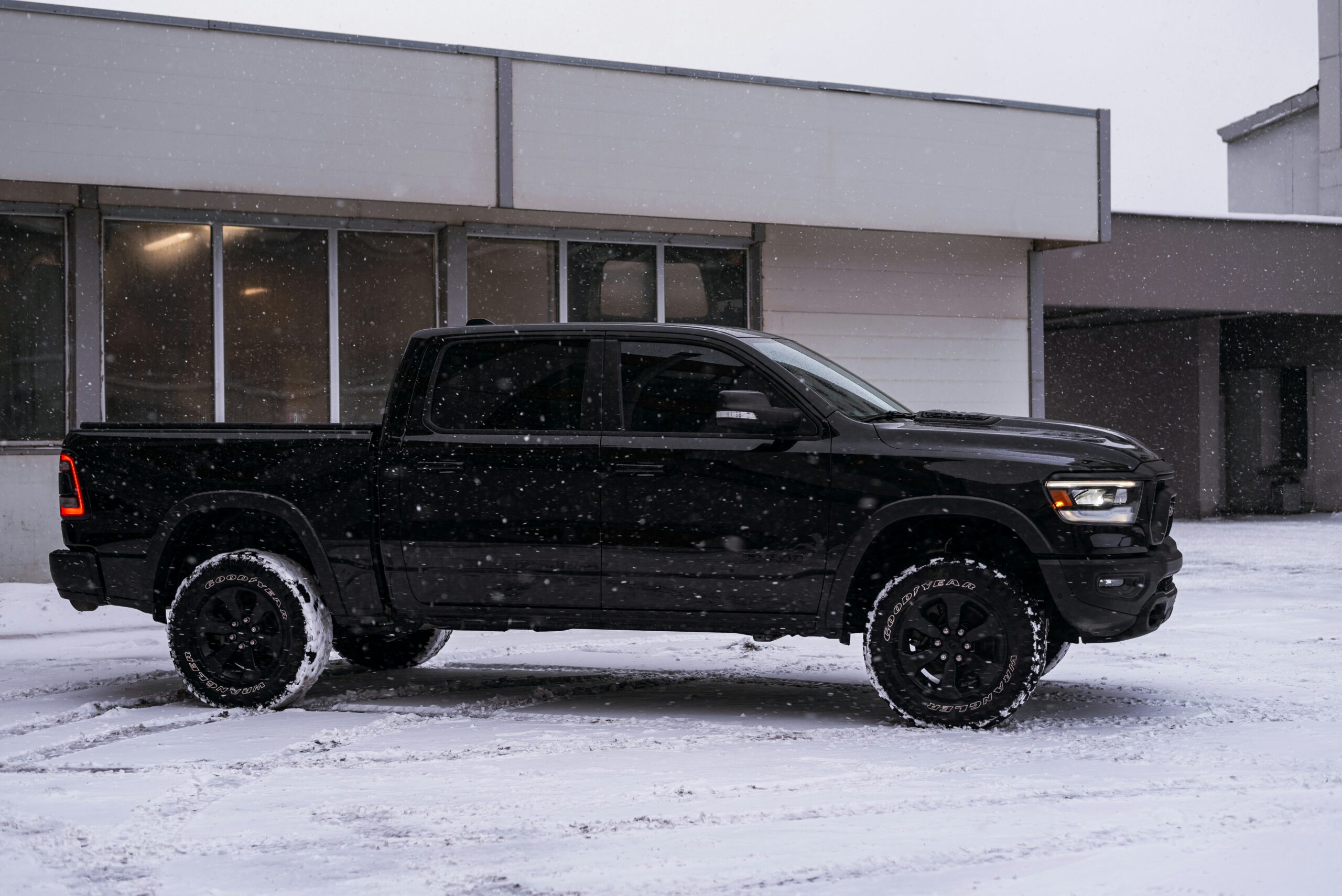 a black truck parked in the snow