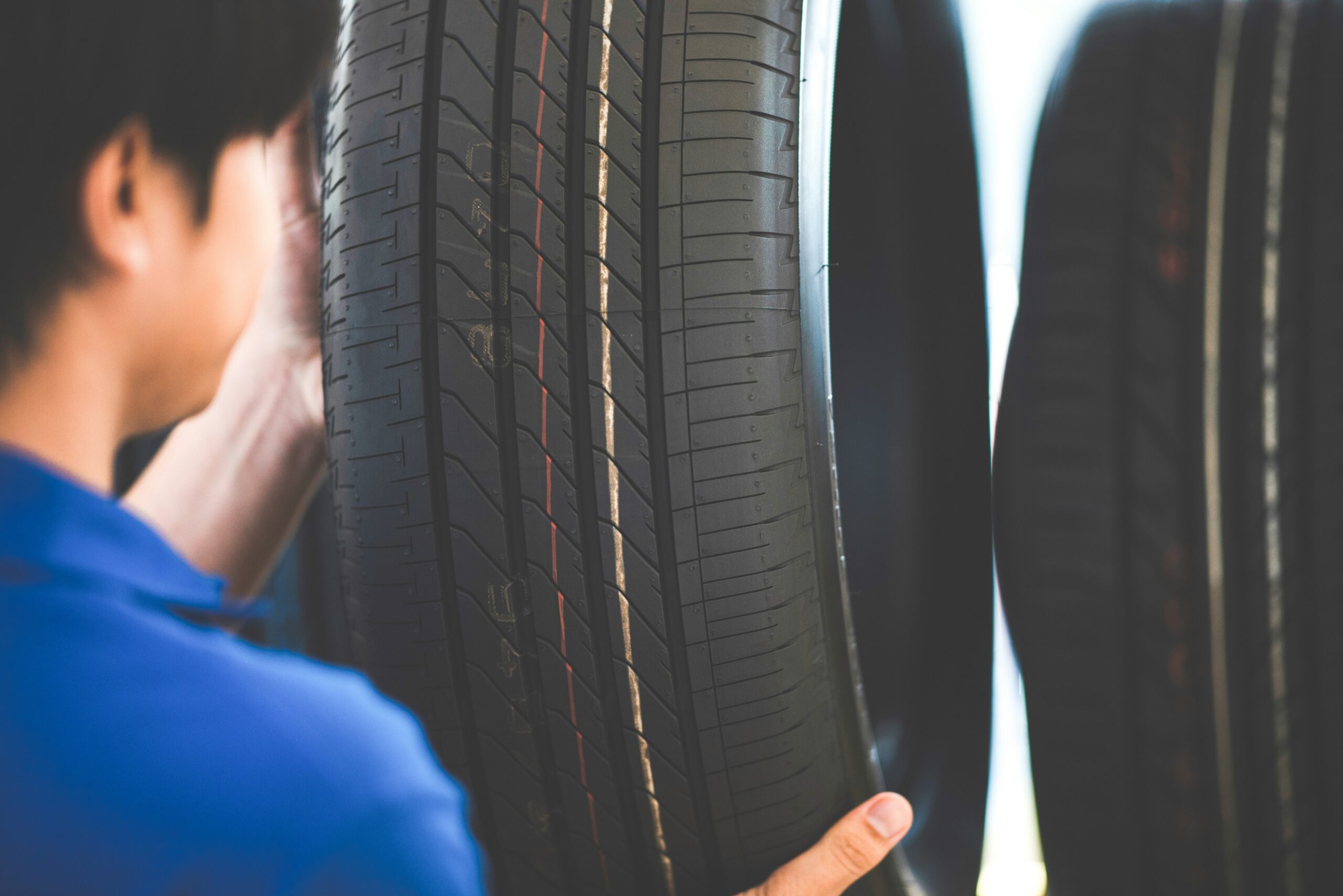 Technician inspecting new tire close-up – showcasing AI-enhanced tire quality checks and inventory management