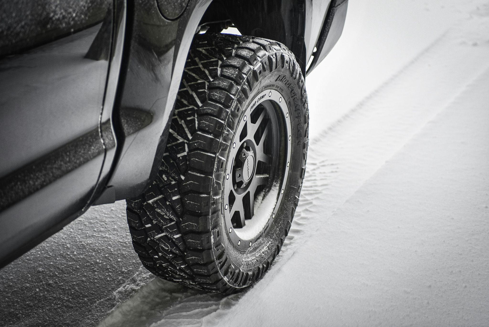 Close-up of a rugged truck winter tire gripping snow for traction and safety - Tires Easy
