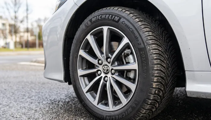 Close-up of a Michelin CrossClimate 2 tire showing the highly popular 205/55R16 sidewall size, the standard recommendation when searching for the best 16" tires for daily commuters.
